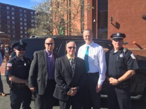 L-R, Lowell Police Officer Thomas Hickey, MCC Executive Director of Public Affairs Patrick Cook, MCC Director of Public Safety Dan Martin, Governor Charlie Baker, and Bedford Police Officer Craig Naylor. (Courtesy Photo)