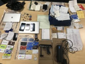 Officers conducting an on-scene investigation during a traffic stop located a silver and black BB gun, dozens of credit cards, a credit card reader and fraudulent driver's licenses in a vehicle. A 27-year-old Woburn man was arrested.