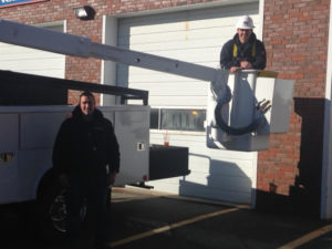 Electricians Matt Bates and Tyler Daniels installed the LED lights on the Fire Department's Central Station. Not pictured, but who assisted with the installation, are electricians Nick Reagan and Chris Hughes. (Courtesy Photo)