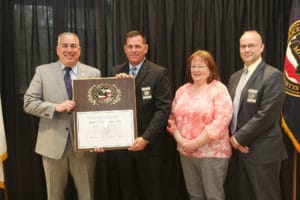 Left-to-right: Chief Robert Bongiorno, Duxbury Chief and Massachusetts Police Accreditation Commission (MPAC) President Matthew M. Clancy, Theresa Blake of the Bedford Police Department and Hamilton Police Chief and MPAC Vice President Russell Stevens. (Courtesy Photo)