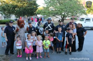 Methuen Police officers pose with children at a neighborhood block party on National Night Out. (Courtesy Photo)